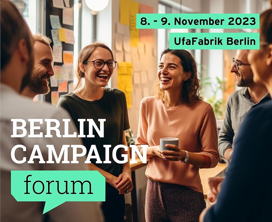  Foto einer Gruppe Menschen, die sich angeregt zu einem Thema austauschen, im Hintergrund sind Tafeln mit Sticky Notes erkennbar. Dazu der Text: "Vom 8. bis 9. November 2023 in der UfaFabrik Berlin."